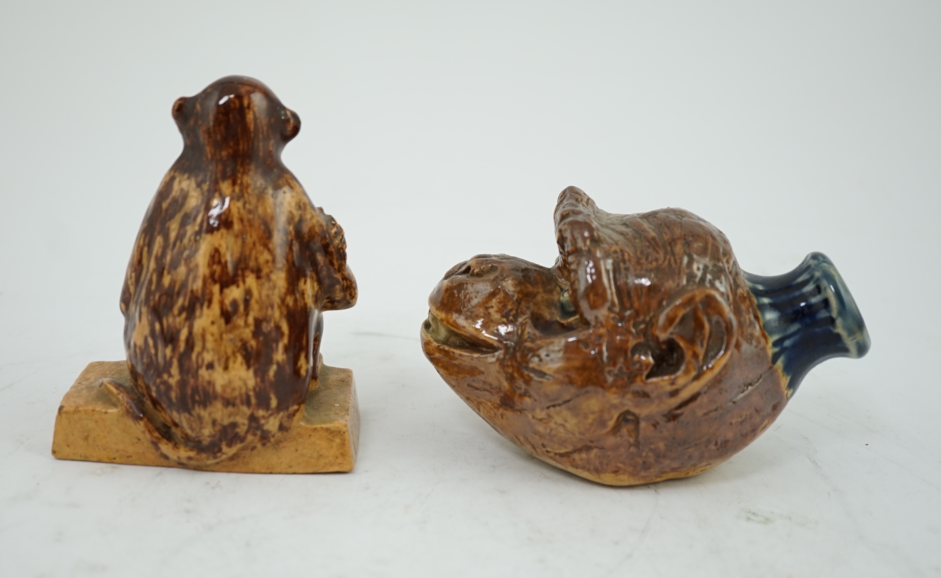 A Clapham Common pottery figure of a seated monkey by J. Frisby Jordan, c.1925, and a stoneware monkey head flask, by JP